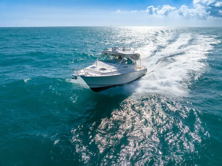  Yacht Photos Pics 2007 Grady-White Express 360 cruising on open ocean under clear blue sky.