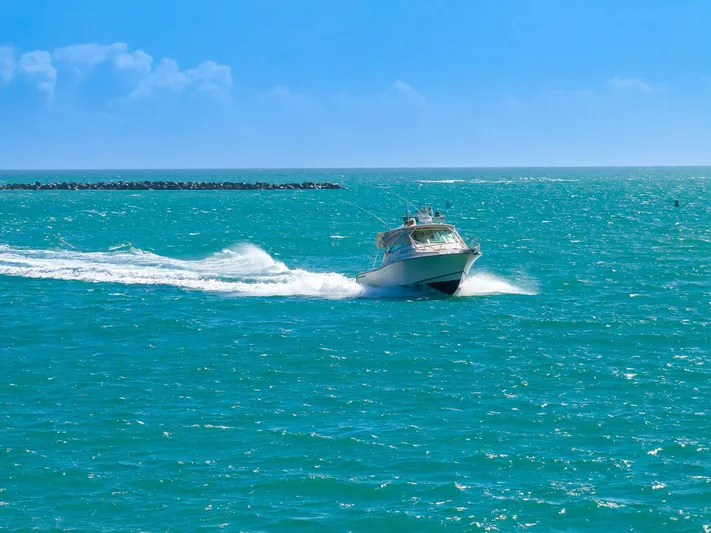  Yacht Photos Pics 2007 Grady-White Express 360 boat cruising on turquoise ocean waters.