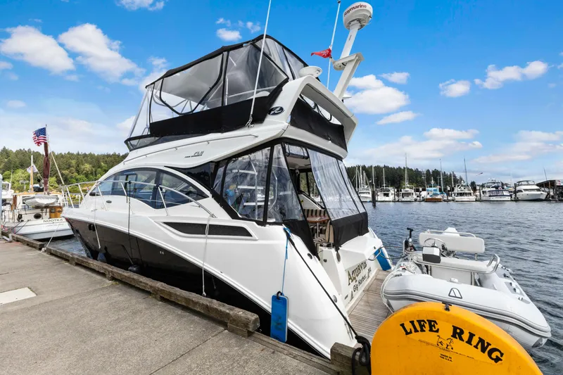  Yacht Photos Pics 2017 Sea Ray 400 Fly yacht docked at marina with inflatable boat and life ring.
