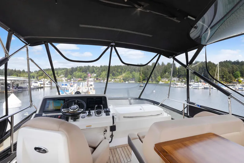  Yacht Photos Pics Flybridge view of 2017 Sea Ray 400 Fly yacht overlooking marina and scenic landscape.