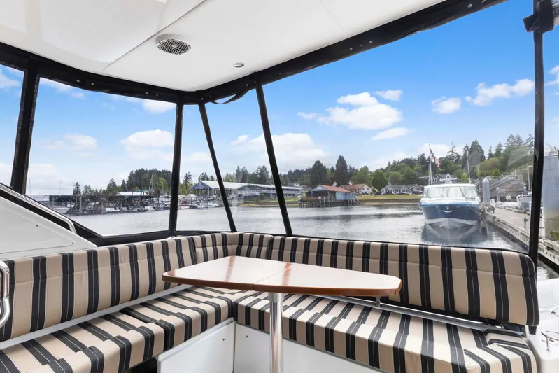  Yacht Photos Pics Interior view of 2017 Sea Ray 400 Fly yacht with striped seating and waterfront scenery.