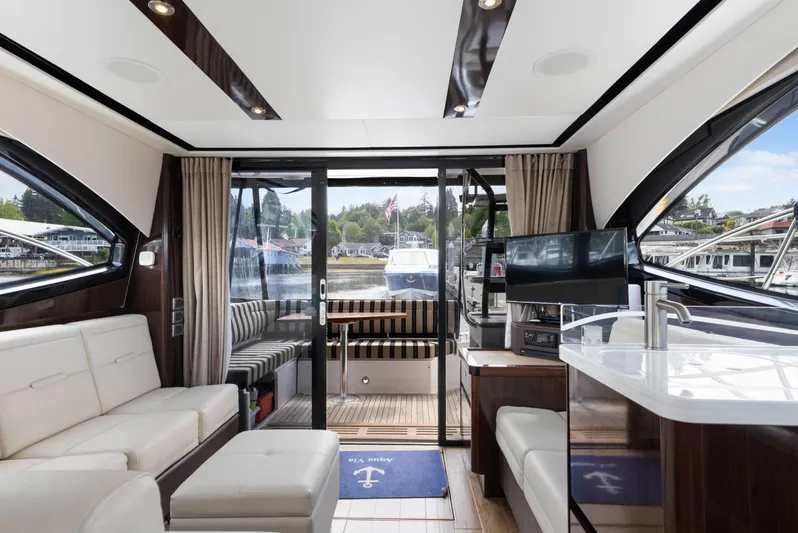  Yacht Photos Pics Luxurious interior of 2017 Sea Ray 400 Fly yacht with modern furnishings and large windows.