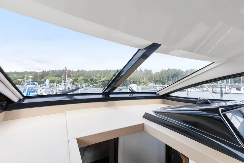  Yacht Photos Pics Interior view from 2017 Sea Ray 400 Fly yacht, showcasing marina and forested shoreline.