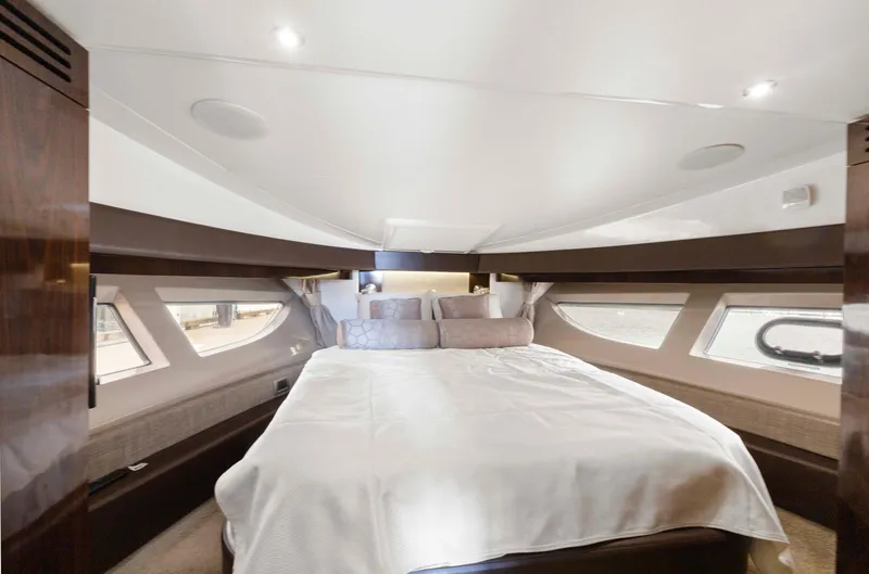  Yacht Photos Pics Luxurious bedroom interior of 2017 Sea Ray 400 Fly yacht with elegant bedding and ambient lighting.