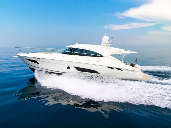 A Ro Boat Yacht Photos Pics 2019 Riviera 4800 Sport Yacht cruising on calm blue waters.