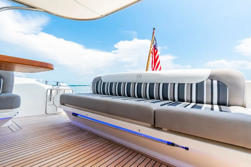 A Ro Boat Yacht Photos Pics 2019 Riviera 4800 Sport Yacht deck with striped seating and American flag.