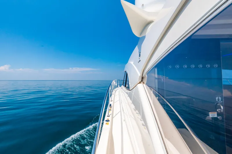 A Ro Boat Yacht Photos Pics Riviera 4800 Sport Yacht 2019 cruising on calm blue ocean under clear sky.