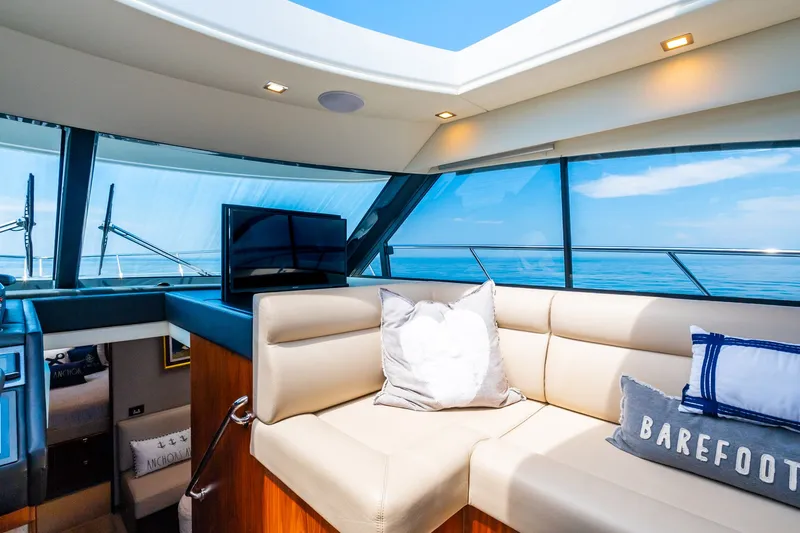 A Ro Boat Yacht Photos Pics Luxurious interior of 2019 Riviera 4800 Sport Yacht with plush seating and ocean view.