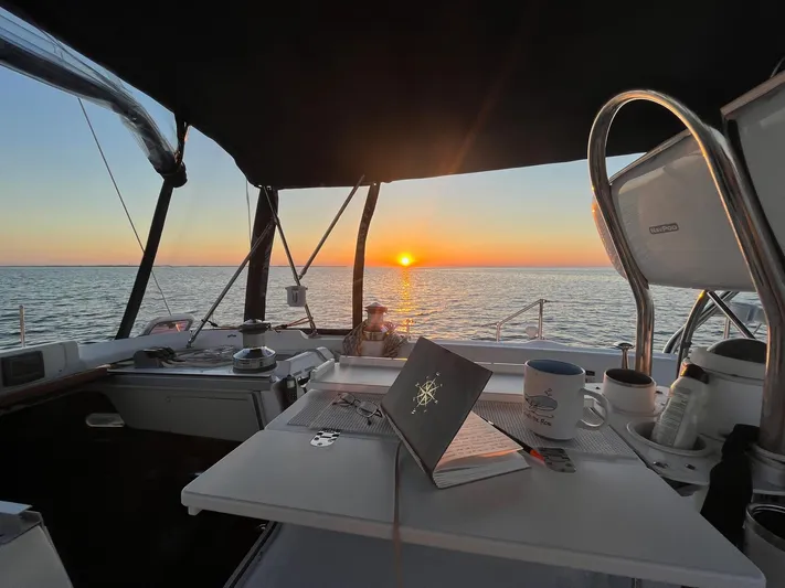  Yacht Photos Pics Sailboat cockpit at sunset with laptop and coffee, Hunter 456, 2005 model.