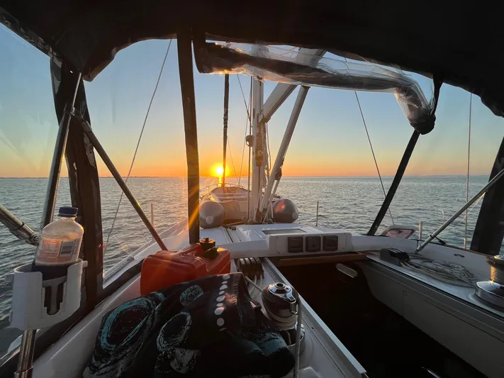  Yacht Photos Pics Sailing on a 2005 Hunter 456 yacht at sunset over calm waters.