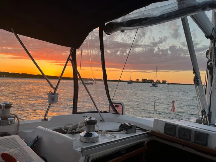  Yacht Photos Pics Sailboat cockpit view at sunset, Hunter 456, 2005 model, serene ocean scene.