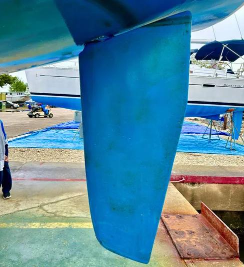  Yacht Photos Pics Blue rudder of a 2005 Hunter 456 sailboat in a boatyard.