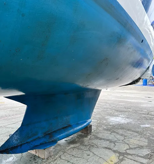 Yacht Photos Pics Blue hull of a 2005 Hunter 456 sailboat on dry dock.