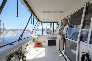 Cuatro Yacht Photos Pics 1998 Bayliner 4788 Pilot House Motoryacht interior with marina view.