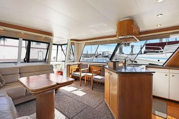 Cuatro Yacht Photos Pics Interior of 1998 Bayliner 4788 Pilot House Motoryacht with spacious seating and large windows.