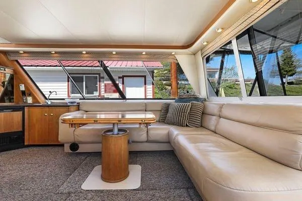 Cuatro Yacht Photos Pics Luxurious interior of 1998 Bayliner 4788 Pilot House Motoryacht with plush seating and elegant design.