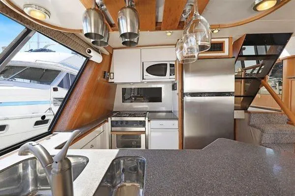 Cuatro Yacht Photos Pics Interior of 1998 Bayliner 4788 Pilot House Motoryacht kitchen with modern appliances.