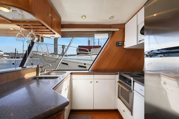 Cuatro Yacht Photos Pics Luxurious kitchen interior of 1998 Bayliner 4788 Pilot House Motoryacht with marina view.