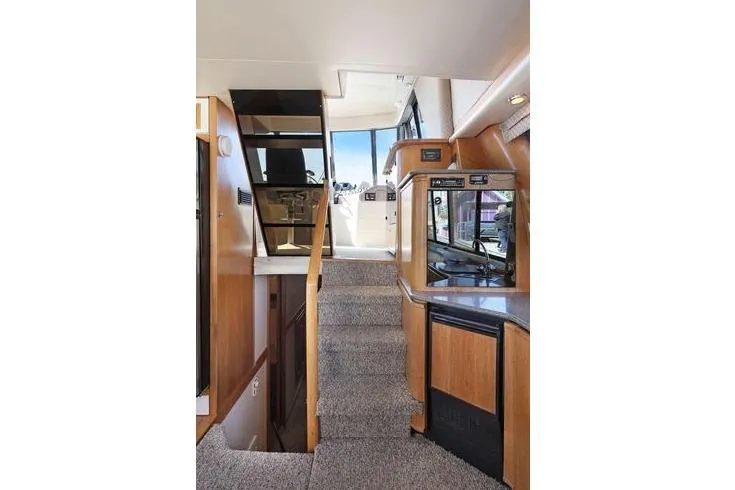 Cuatro Yacht Photos Pics Interior of 1998 Bayliner 4788 Pilot House Motoryacht with stairs and modern amenities.