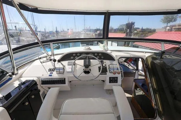 Cuatro Yacht Photos Pics 1998 Bayliner 4788 Pilot House Motoryacht helm with panoramic marina view.