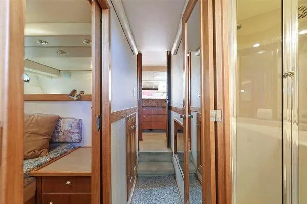 Cuatro Yacht Photos Pics Interior of 1998 Bayliner 4788 Pilot House Motoryacht with wood accents and cozy seating.