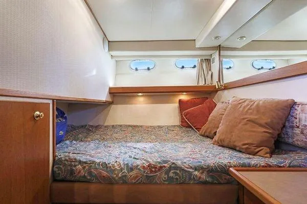 Cuatro Yacht Photos Pics Cozy cabin interior of 1998 Bayliner 4788 Pilot House Motoryacht with plush bedding.