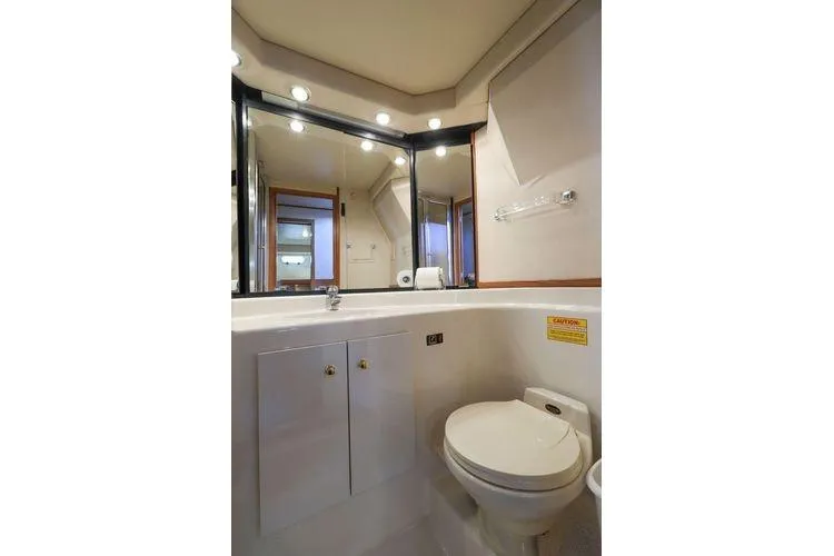 Cuatro Yacht Photos Pics Bathroom interior of 1998 Bayliner 4788 Pilot House Motoryacht, featuring modern fixtures and lighting.