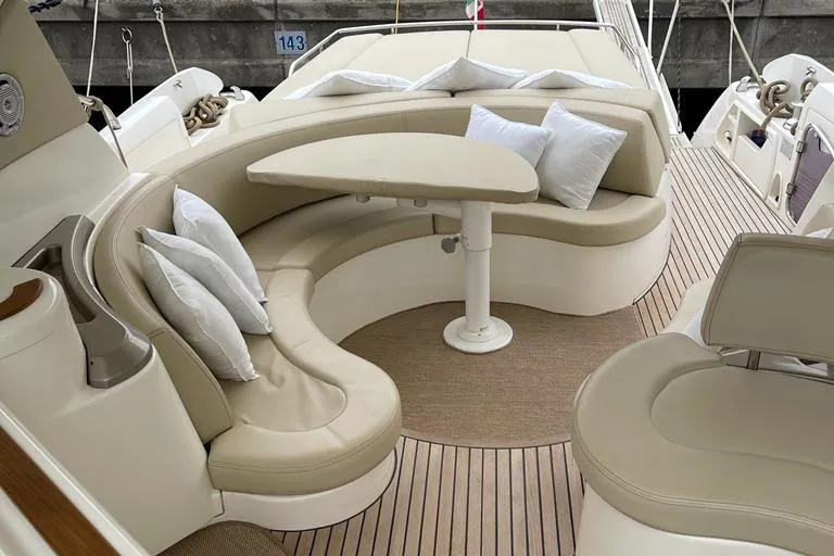  Yacht Photos Pics Luxurious seating area on a 2009 Jeanneau Prestige 50 HT yacht with cushions and table.