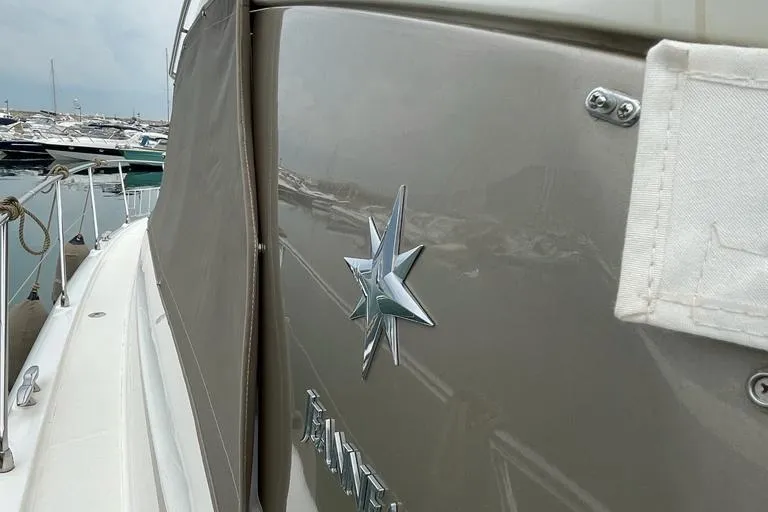  Yacht Photos Pics 2009 Jeanneau Prestige 50 HT yacht with star emblem, docked in marina.