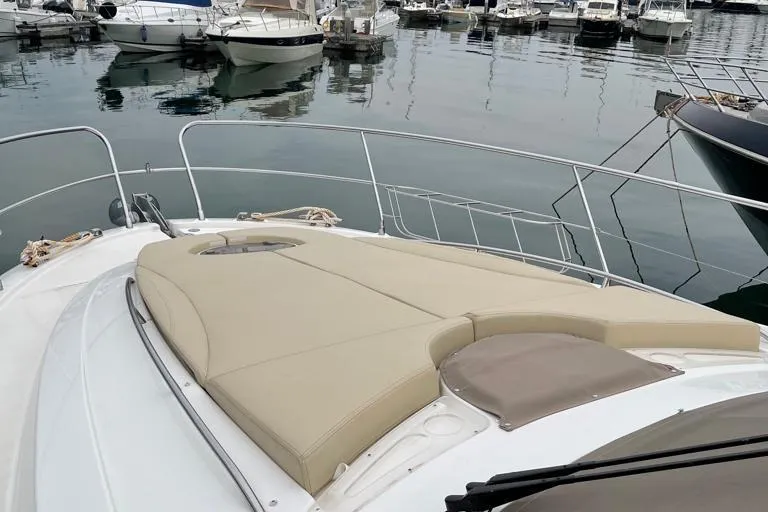  Yacht Photos Pics Luxurious 2009 Jeanneau Prestige 50 HT yacht with spacious sunbathing deck in marina.