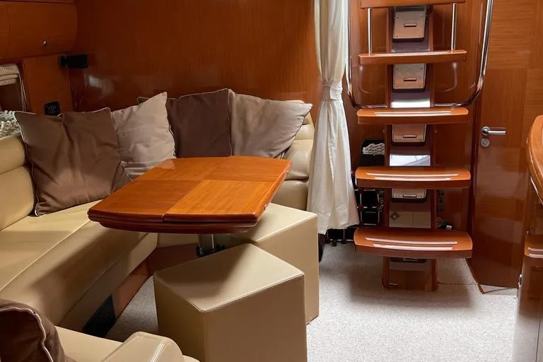  Yacht Photos Pics Luxurious interior of 2009 Jeanneau Prestige 50 HT yacht with plush seating and wooden accents.