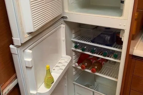  Yacht Photos Pics Open fridge in 2009 Jeanneau Prestige 50 HT yacht, stocked with drinks and condiments.