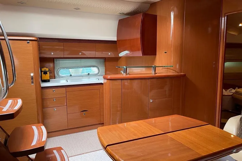  Yacht Photos Pics Luxurious interior of 2009 Jeanneau Prestige 50 HT yacht with wooden cabinetry and modern design.