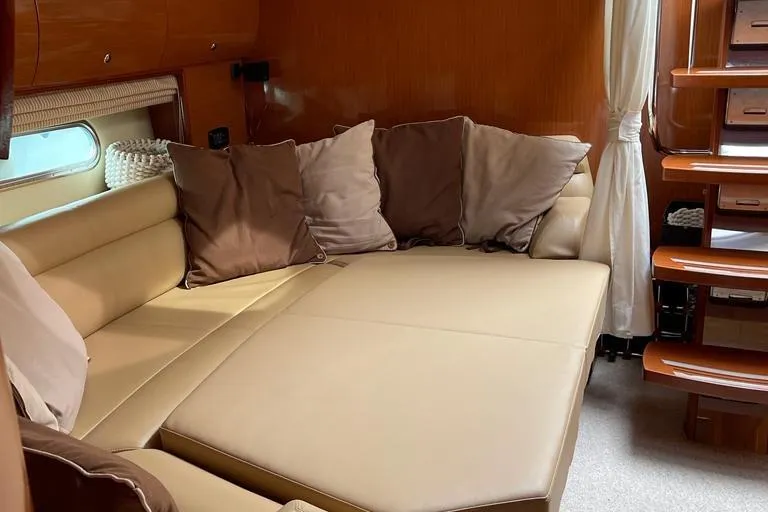  Yacht Photos Pics Luxurious interior of 2009 Jeanneau Prestige 50 HT yacht with beige seating and cushions.