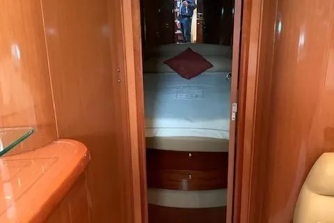  Yacht Photos Pics Interior cabin of 2009 Jeanneau Prestige 50 HT yacht with cozy bed and wooden finish.