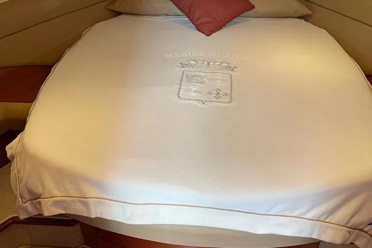  Yacht Photos Pics Luxurious cabin interior of 2009 Jeanneau Prestige 50 HT yacht with embroidered bedding.