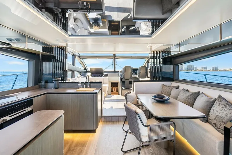  Yacht Photos Pics Luxurious interior of 2025 Pearl 63 yacht with modern kitchen and dining area.
