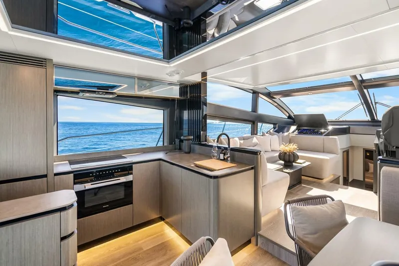  Yacht Photos Pics Luxurious interior of 2025 Pearl 63 yacht with modern kitchen and ocean view.