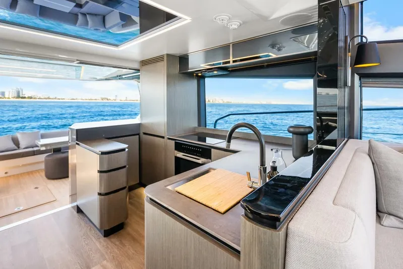  Yacht Photos Pics Luxurious interior of 2025 Pearl 63 yacht with ocean view and modern kitchen.