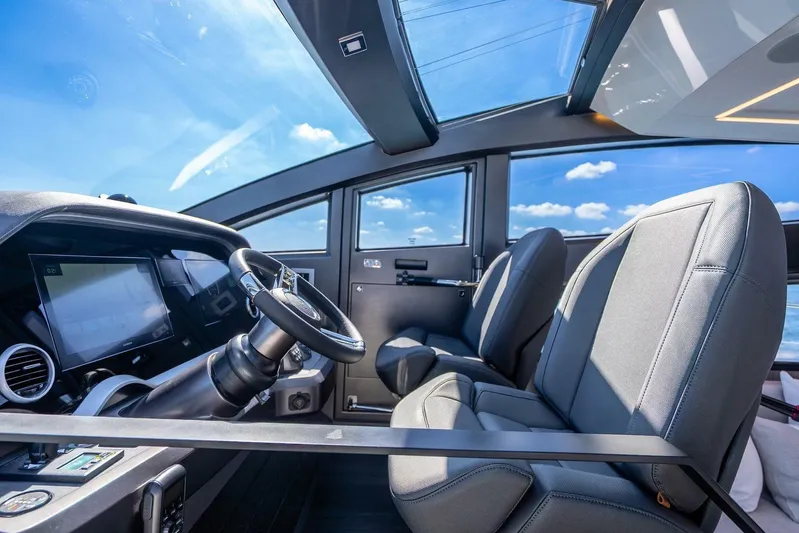  Yacht Photos Pics Interior of 2025 Pearl 63 yacht cockpit with modern steering and seating.
