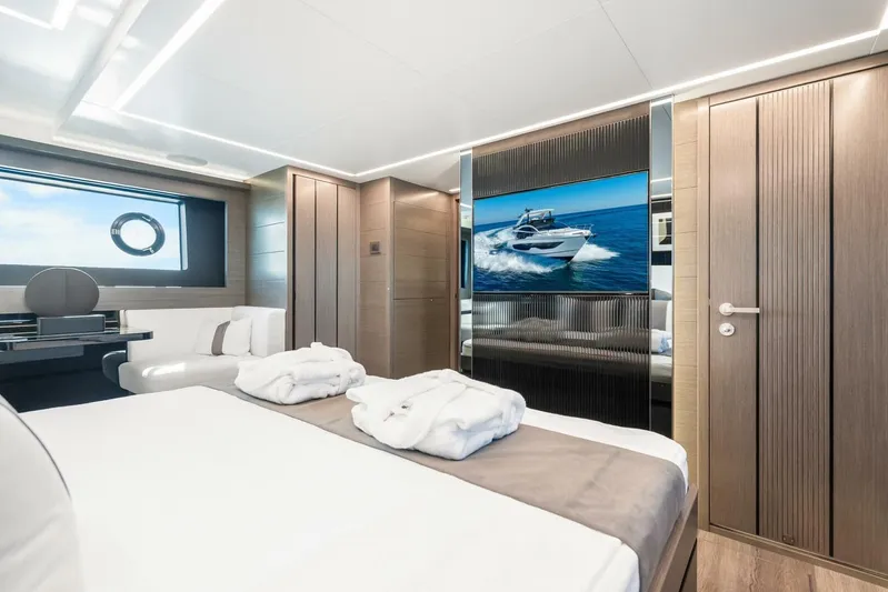  Yacht Photos Pics Luxurious bedroom interior of 2025 Pearl 63 yacht with modern design and ocean view.