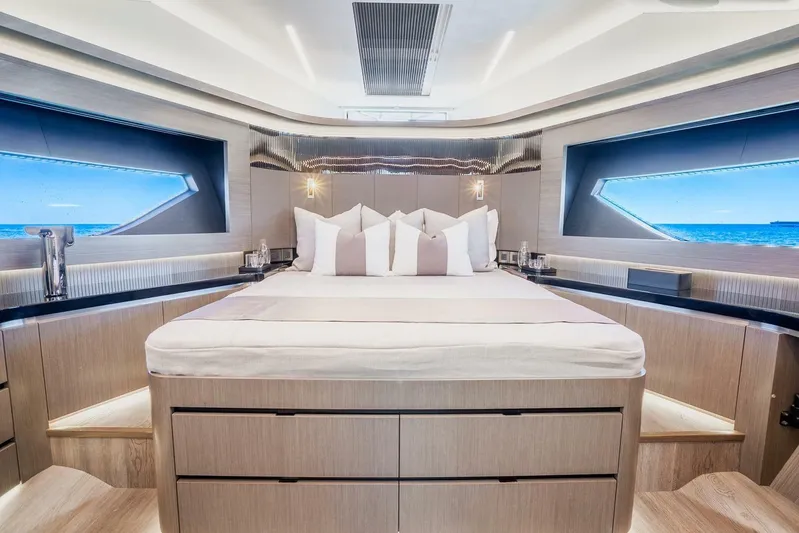  Yacht Photos Pics Luxurious bedroom interior of 2025 Pearl 63 yacht with ocean view windows.