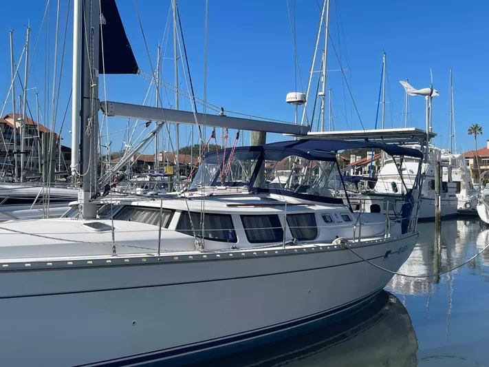 No Agenda Yacht Photos Pics 2003 Jeanneau Deck Salon sailboat docked in a marina under clear blue skies.