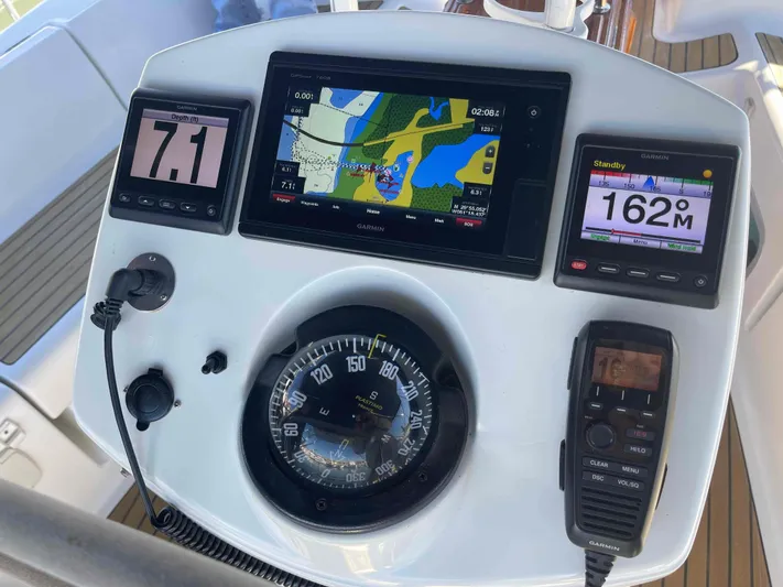 No Agenda Yacht Photos Pics 2003 Jeanneau Deck Salon navigation console with compass, GPS, and digital displays.