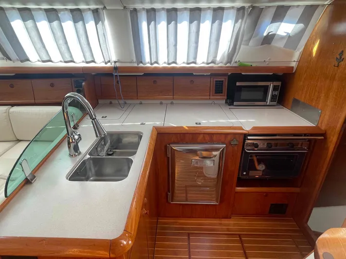 No Agenda Yacht Photos Pics 2003 Jeanneau Deck Salon kitchen with dual sinks, microwave, and oven.
