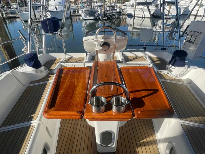 No Agenda Yacht Photos Pics 2003 Jeanneau Deck Salon yacht cockpit with wooden table and marina view.