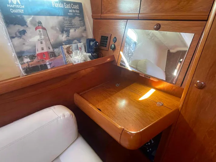 No Agenda Yacht Photos Pics 2003 Jeanneau Deck Salon interior with wooden desk, mirror, and nautical chart.