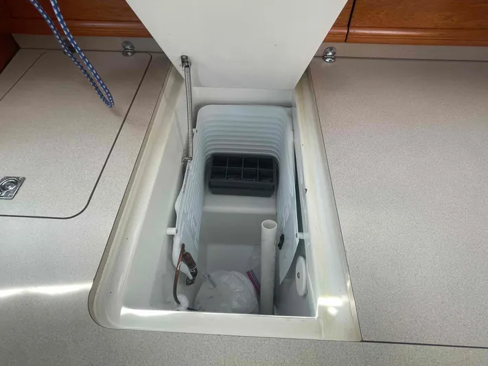 No Agenda Yacht Photos Pics 2003 Jeanneau Deck Salon interior storage compartment with open lid.