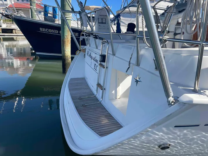 No Agenda Yacht Photos Pics 2003 Jeanneau Deck Salon sailboat docked in marina, rear view.