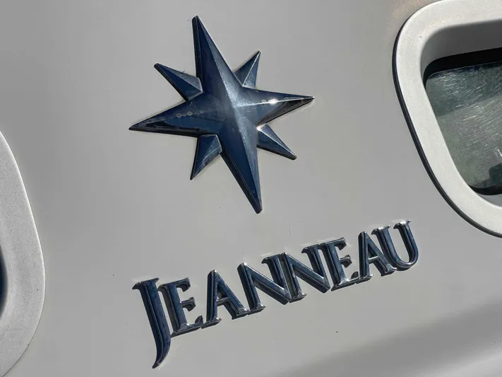 No Agenda Yacht Photos Pics Jeanneau Deck Salon 2003 logo on boat exterior with star emblem.